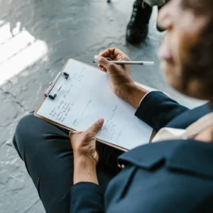 Shows a trauma therapist in Fort Worth, TX taking notes in therapy. Represents how trauma therapy Fort Worth can help you feel supported.